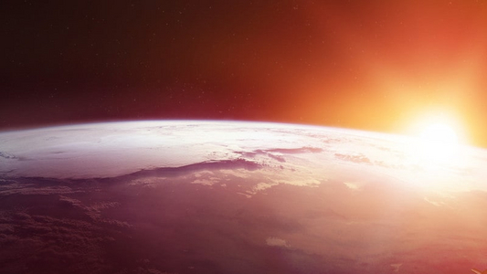 Photo: Erde aus dem Weltall mit aufgehender Sonne dahinter.