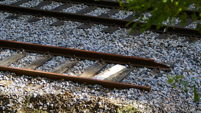 Photo: Two railway tracks, one of which ends.