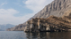 Rocky coastline along the Strait of Hormuz in northern Oman, with steep cliffs rising directly from the sea.